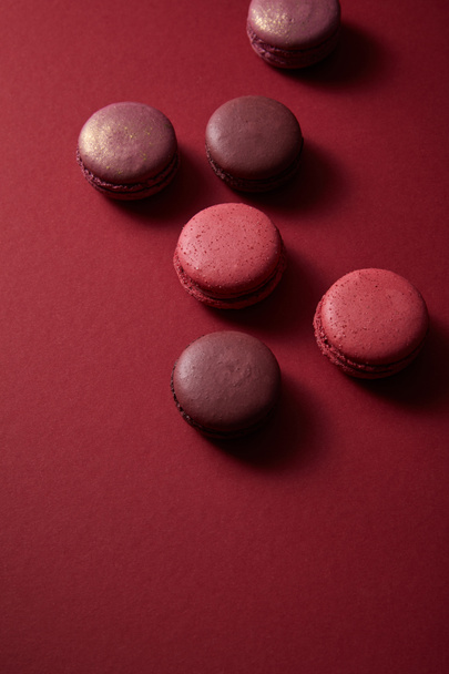delicious colorful french macaroons on red background - Foto, Bild