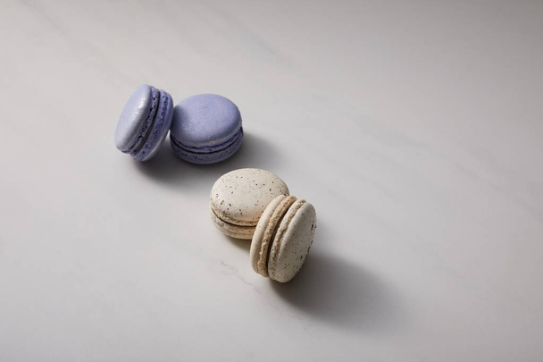 assorted delicious violet and white  french macaroons on grey background - Foto, immagini