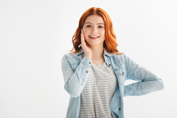 happy redhead teen girl in denim clothes, isolated on white - Foto, afbeelding