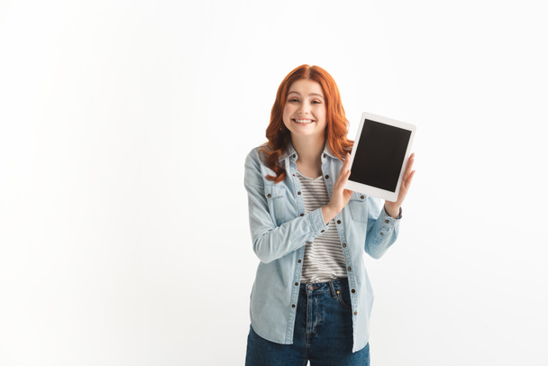 cheerful teen girl showing digital tablet with blank screen, isolated on white - Photo, Image