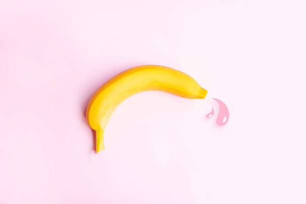 Koncept předčasné ejakulace antikoncepce. Velký žlutý banán a kapky tekutiny. - Fotografie, Obrázek