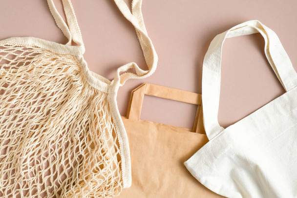 Kraft paper bag, produce cotton bag and grocery mesh bag top view. Various type of eco-friendly shopping bag. Zero waste concept - Fotó, kép