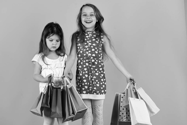 Shopaholics, childhood and fashion concept. Ladies buy clothes - Foto, afbeelding