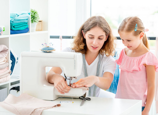 Little girl is taught to sew - Photo, image