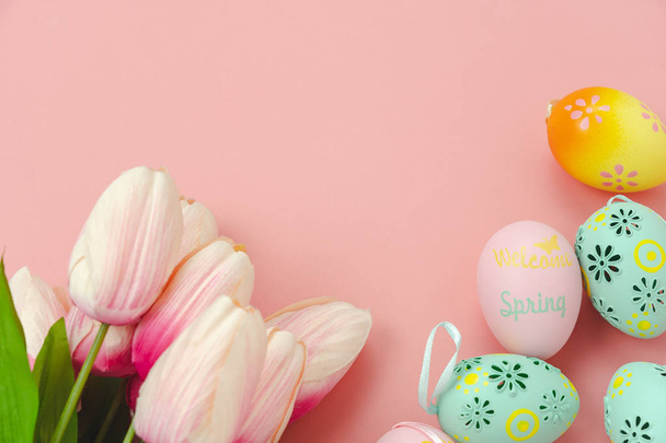 Tabel bovenaanzicht shot van de versieringen Happy Easter concept achtergrond vakantie. Plat leggen eenvoudige minimale bunny eieren & met tulp op moderne rustieke roze papier. Ruimte voor creatief ontwerp mock up & sjabloon kopiëren - Foto, afbeelding