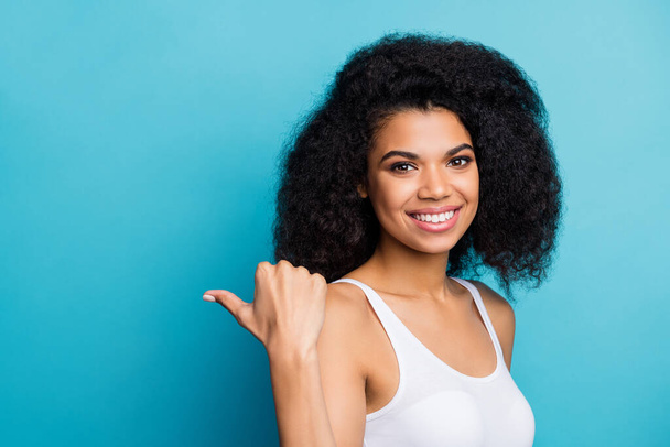 Close-up portrait of her she nice attractive cheerful cheery confident wavy-haired girl pointing thumb aside advert copy space isolated on bright vivid shine vibrant blue color background - Photo, Image