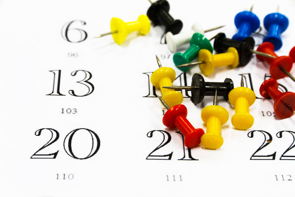 colorful push pins on calendar close-up view - Photo, Image