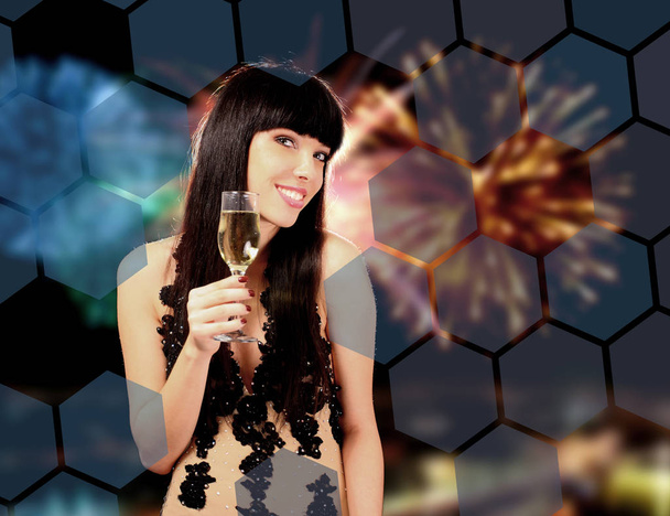 Sexy happy woman with champagne over fireworks background  - Valokuva, kuva