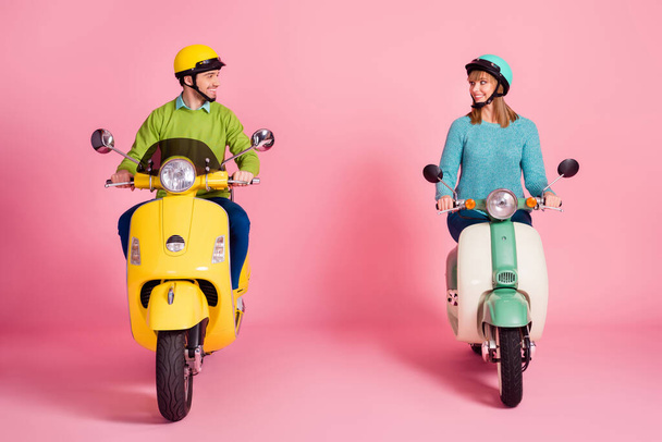 Full body photo of funny lady guy driving two vintage moped spend vacation together safe road meet adventures wear casual outfit colorful headgear isolated pink color background - Foto, Bild