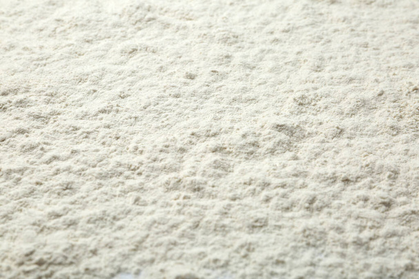 Pile of organic flour as background, closeup - 写真・画像