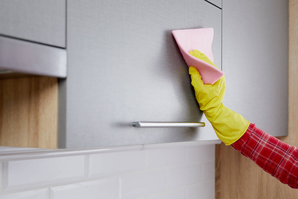 Woman hand in gloves cleaning kitchen - Foto, Imagen
