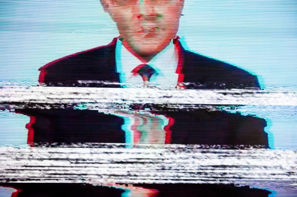 Man in a suit on the screen. Broadcaster. Glitch. Digital errors on the screen.  - Photo, Image
