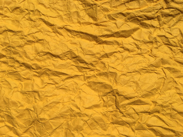 デザインのための黄色のしわ紙の背景。テキストまたは作業用のスペースのコピー  - 写真・画像