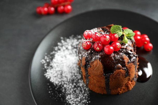 Delicious warm chocolate lava cake with mint and berries on table, closeup. Space for text - Photo, Image
