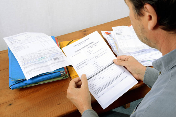 Anonymous man in debt with credit and bill files  - Photo, Image