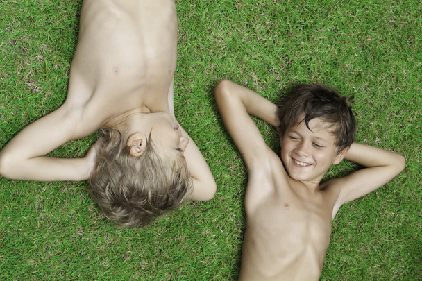 Two boys lying on the grass - Fotó, kép