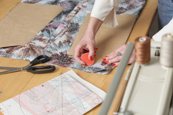 Fashion designer working with fabric in fashion studio. - Фото, изображение