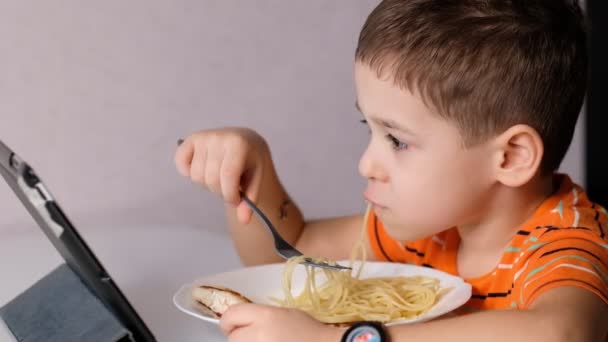 child playing with pasta at dining table. messy face eating. sauce and kid. boy eats pasta noodles sitting in nursery cafe. Happy child eating healthy organic and vegan food in restaurant. - Filmmaterial, Video