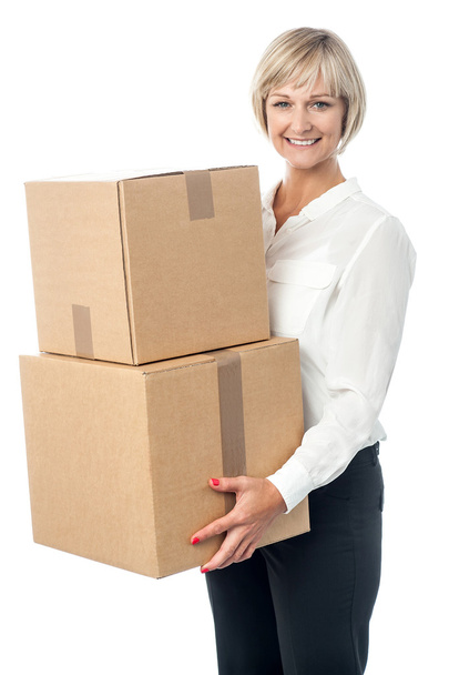 Middle aged woman moving packed boxes - Fotó, kép