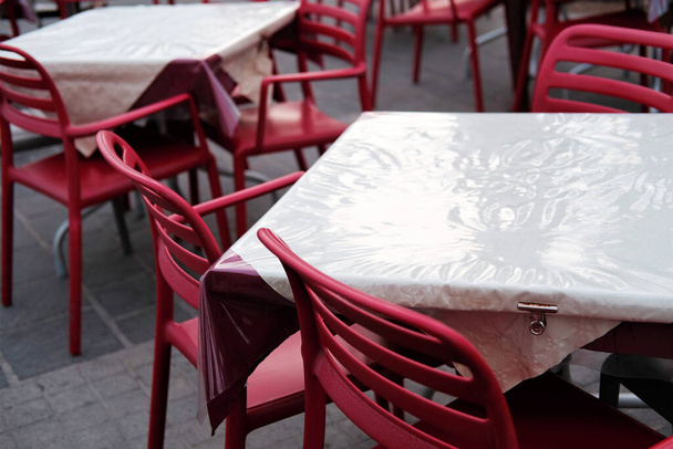 puste krzesła i stoły w restauracji przy złej pogodzie poza sezonem. - Zdjęcie, obraz