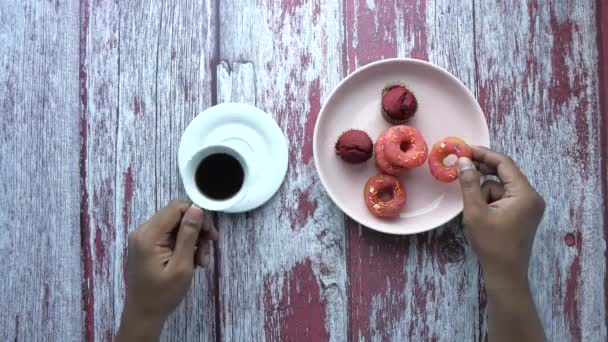 top view of coffee and donuts on table - Footage, Video