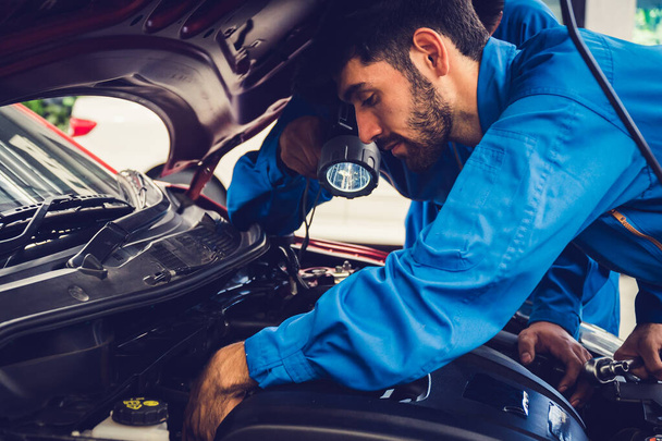 Mechanics checking and repairing the car. Car auto services concepts - Photo, Image