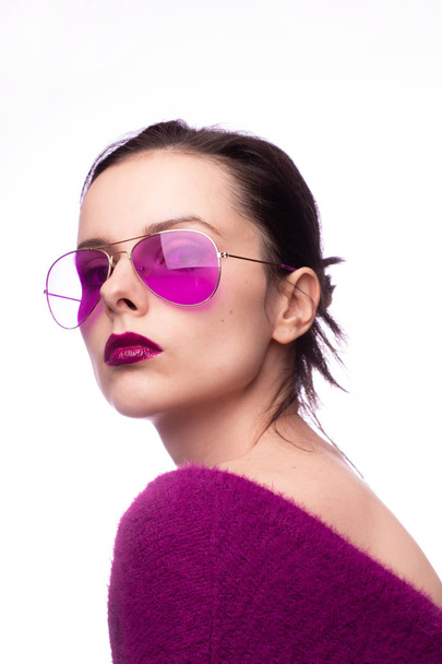 girl in a purple sweater, purple glasses with purple lipstick on her lips - Foto, Imagem