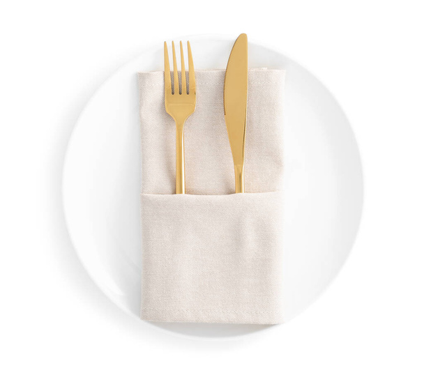 Stylish elegant cutlery with napkin in plate isolated on white, top view - Foto, Bild