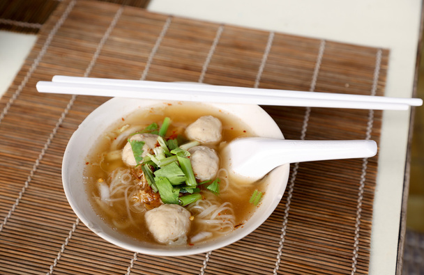 Meat balls noodle in a white bowl with chopsticks - Photo, Image