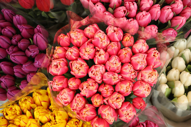 Beautiful bouquets of tulip flowers, top view. Floral decor - Фото, изображение