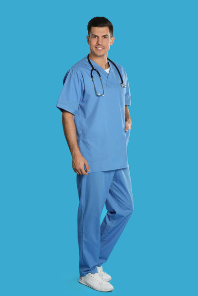 Portrait of doctor with stethoscope on blue background - Photo, Image