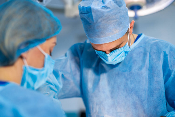 Spinal surgery. Group of surgeons in operating room with surgery equipment. Modern medical background - 写真・画像