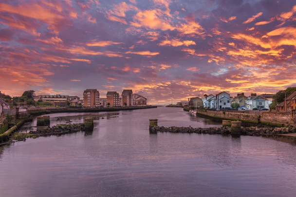 From the New Bridge at Ayr looking over the ruined foundations and pillars of the old bridge in the historic town of Ayr in Scotland all at sunset. - Photo, Image