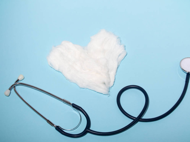 medicine the concept of the stethoscope near the heart of cotton wool. blank for designers. medicine and healthcare - 写真・画像