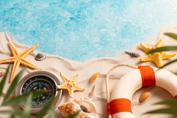 Minimal exotic concept. Creative layout of sand waves and sea, summer beach background with shell, sea star, compass life preserver and blurred Palm vacation and travel concept, Flat lay top view - Foto, Imagem