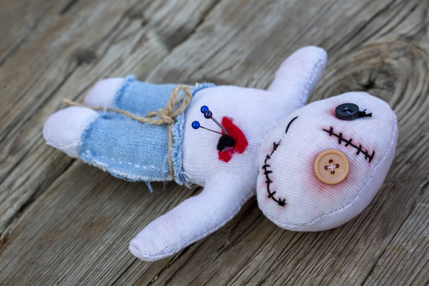Voodoo doll on the wooden background - Photo, Image