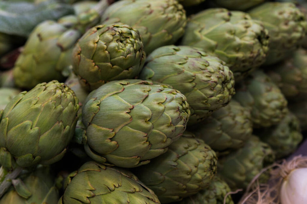 Stock photo of a close-up of a bunch of artichokes at a market stall - Photo, Image