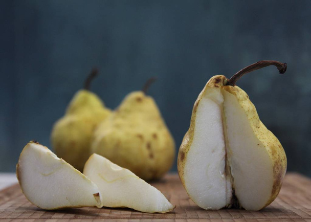 Lying notched pear on the background of two others - Foto, Imagem