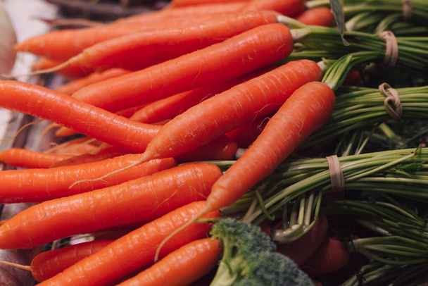 Stockfoto van een close-up van een stel verse wortelen op een marktkraam - Foto, afbeelding