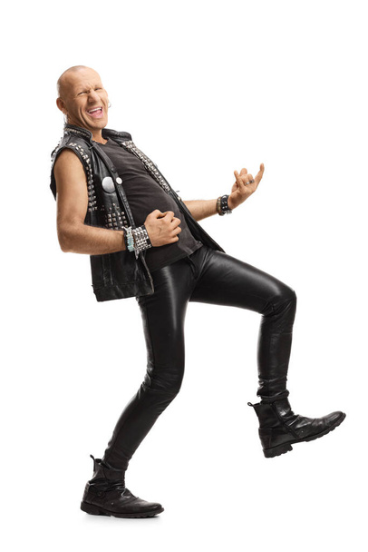 Full length shot of a punk pretending to play a guitar isolated on white background - Photo, Image