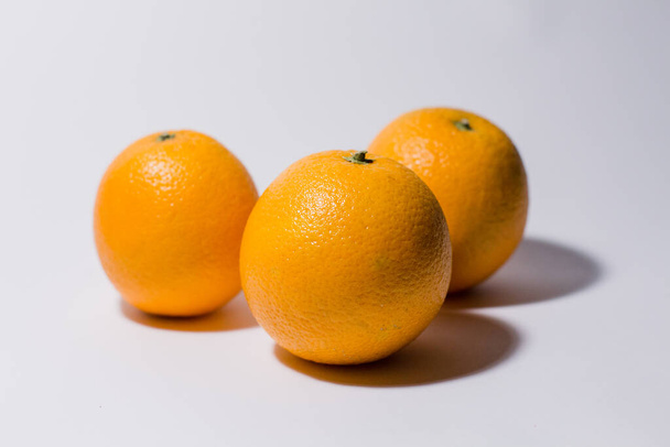 ripe oranges on a white background - Foto, imagen