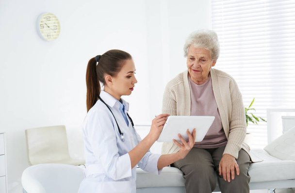 Senior woman visiting doctor in modern office - Photo, Image