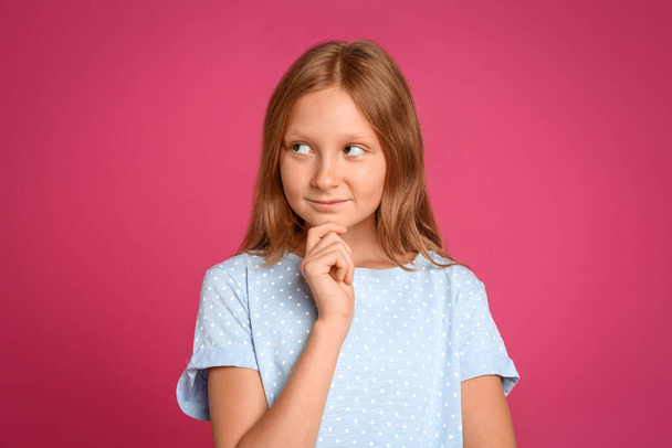 Portrait of preteen girl on pink background - Foto, imagen