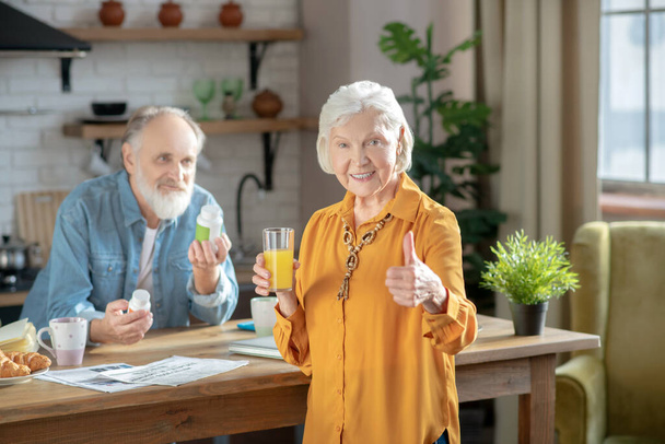 Happy elderly couple having a healthy breakfast together - Photo, Image