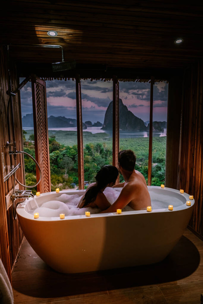 sunset in bathtub in the bathroom during vacation in Thailand watching sunset over the ocean and moutnains Phangnga Bay Thailand - Foto, Bild