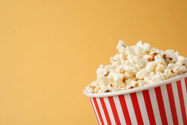 Delicious popcorn on yellow background, closeup. Space for text - Foto, imagen