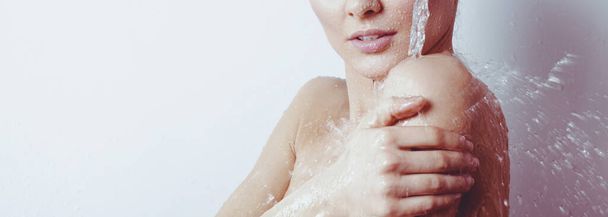 Young beautyful woman under shower in bathroom - Photo, image