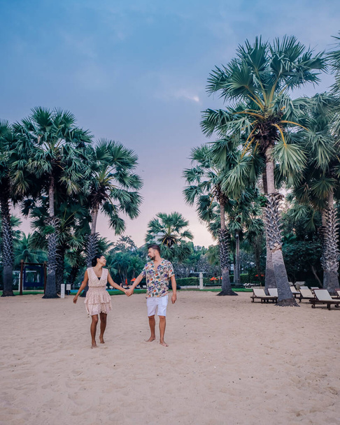 NaJomtien Pattaya Thailand, couple men and woman walking on the beach during sunrise in Pattaya Thailand - 写真・画像