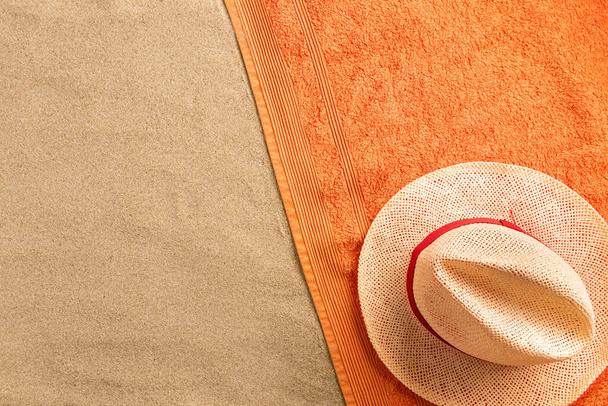 Top view straw hat with copy space. Traveler accessories on sand. Travel vacation concept. Summer background - Фото, зображення