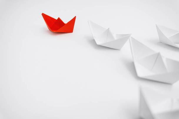 Business and Leadership. Unique Paper Boat Leading The Rest By Example. - Photo, Image